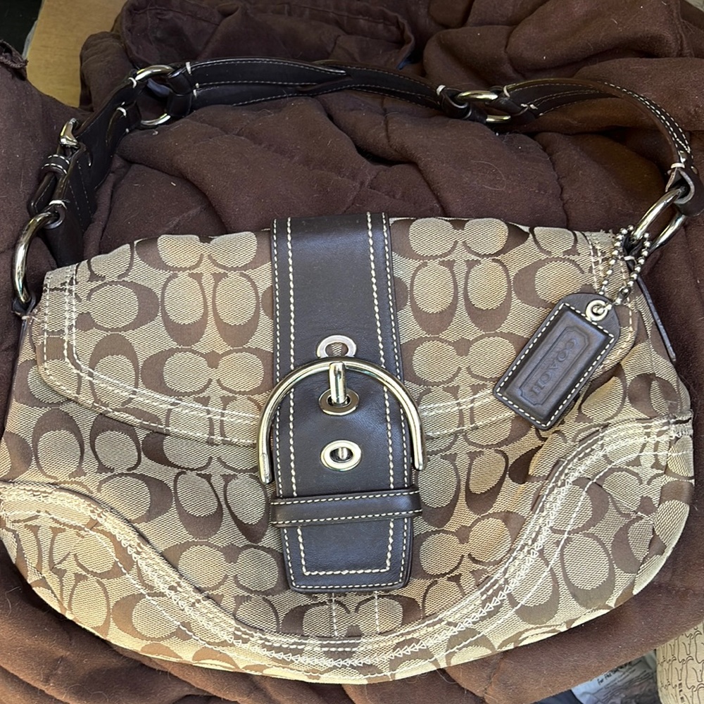 Tan and brown Coach purse with buckle